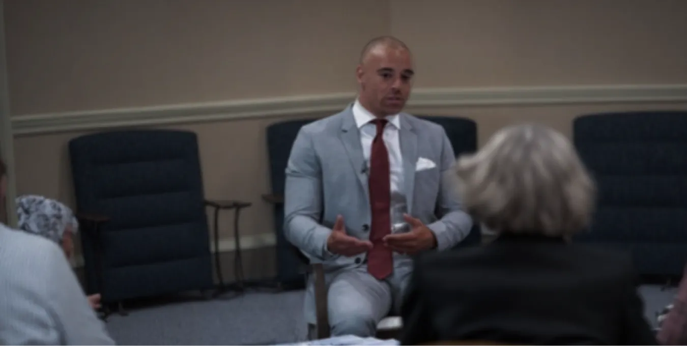 Charles discussing property with a small group